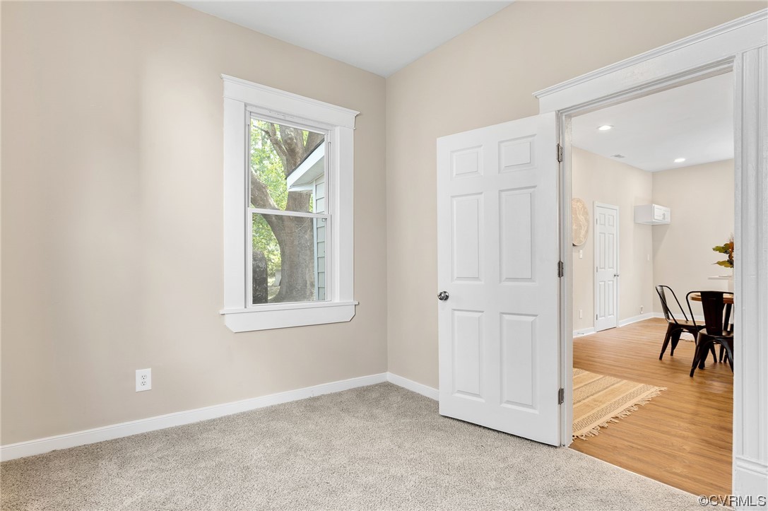 117 Spring Street Petersburg, VA 23803 - Photo 12 of 22 an empty room with wooden floor and windows