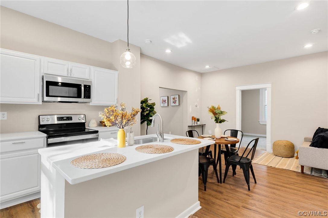 117 Spring Street Petersburg, VA 23803 - Photo 7 of 22 a kitchen with sink a microwave and dining table