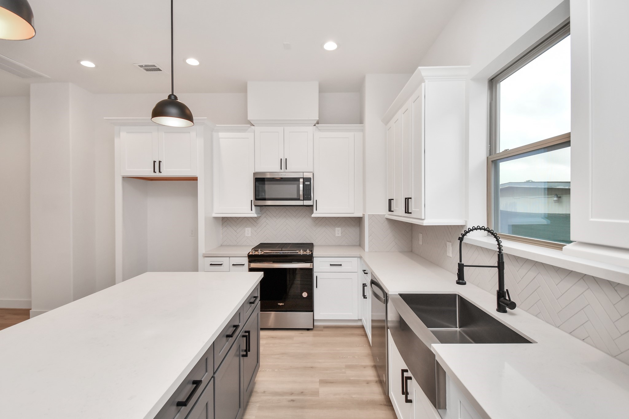2335 Eagle Street Houston, TX 77004 - Photo 12 of 26 a kitchen with stainless steel appliances granite countertop a sink a stove and a refrigerator