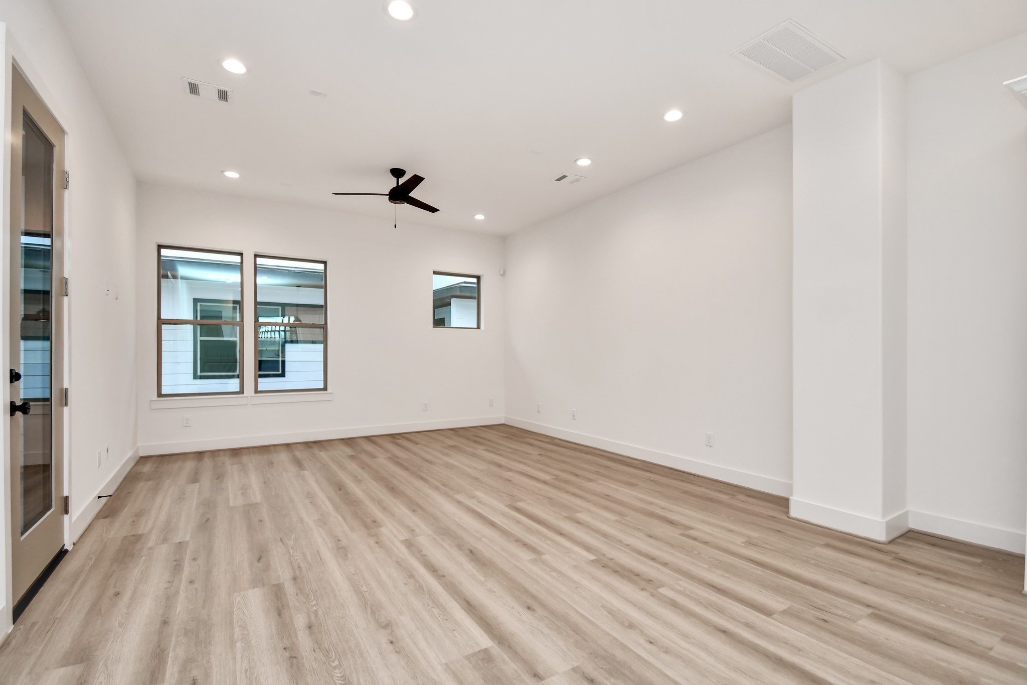 2335 Eagle Street Houston, TX 77004 - Photo 14 of 26 an empty room with wooden floor and windows