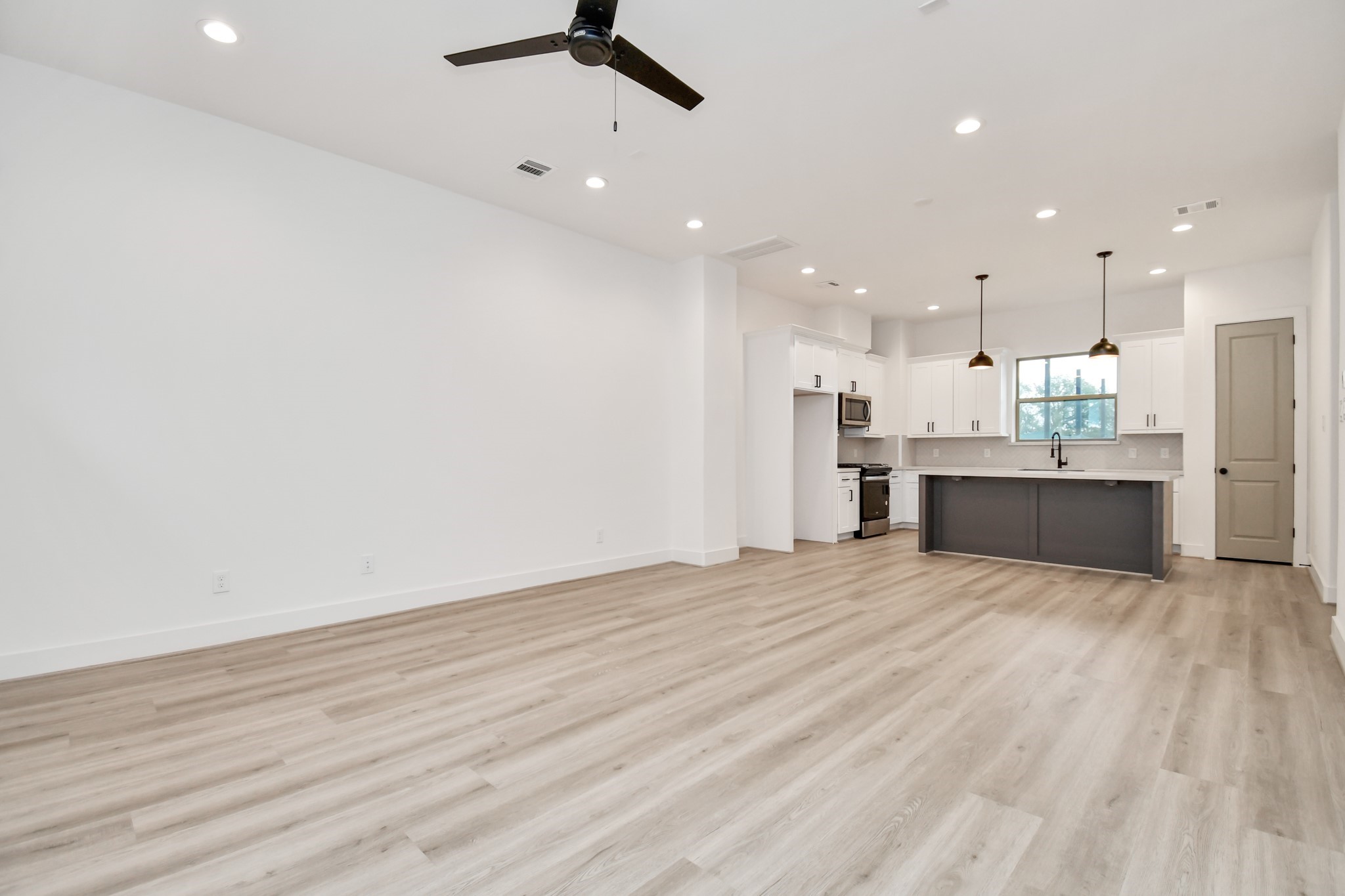 2335 Eagle Street Houston, TX 77004 - Photo 16 of 26 a view of kitchen with kitchen island stainless steel appliances refrigerator stove microwave and cabinets