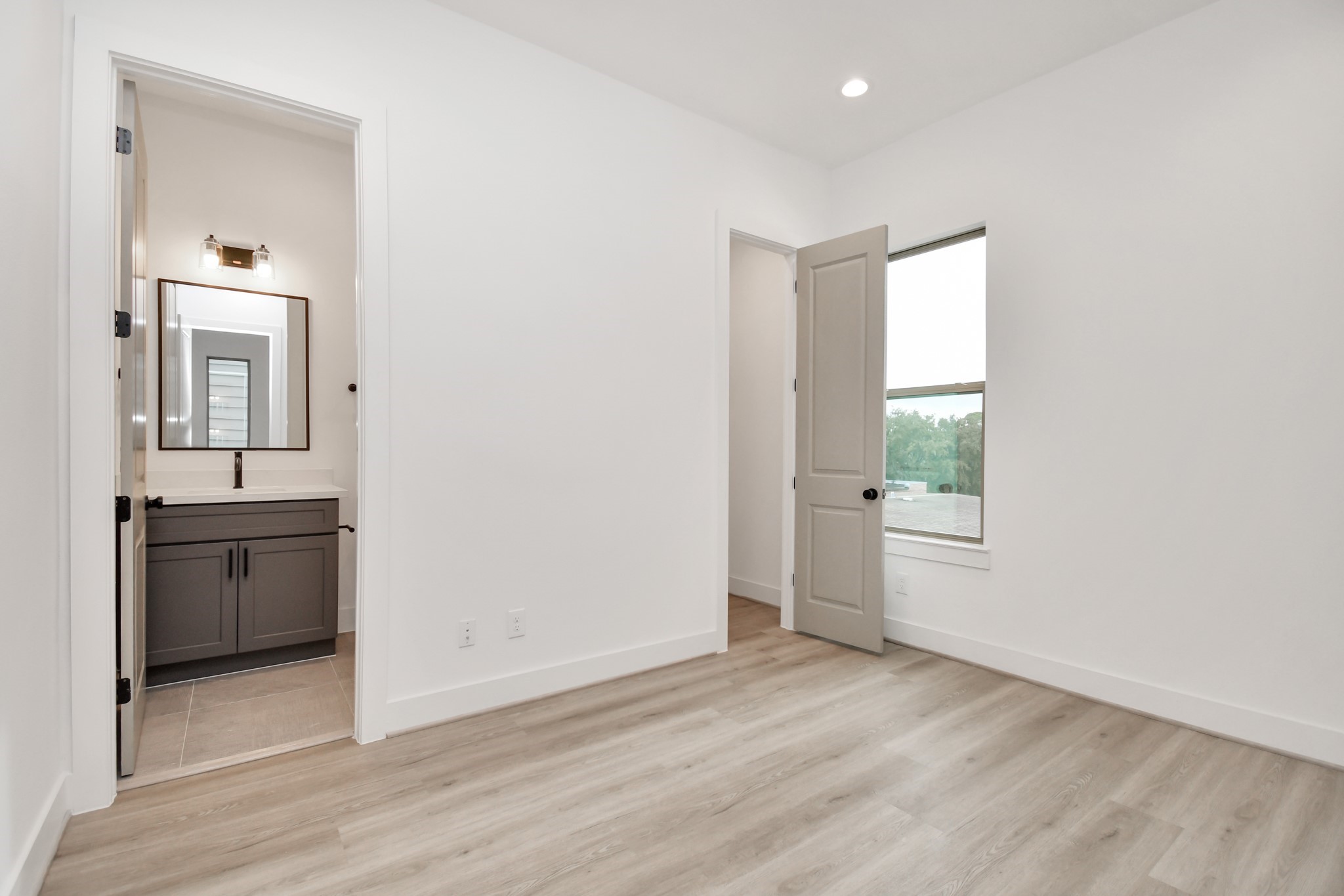 2335 Eagle Street Houston, TX 77004 - Photo 18 of 26 a view of a kitchen from the hallway with a sink and a mirror