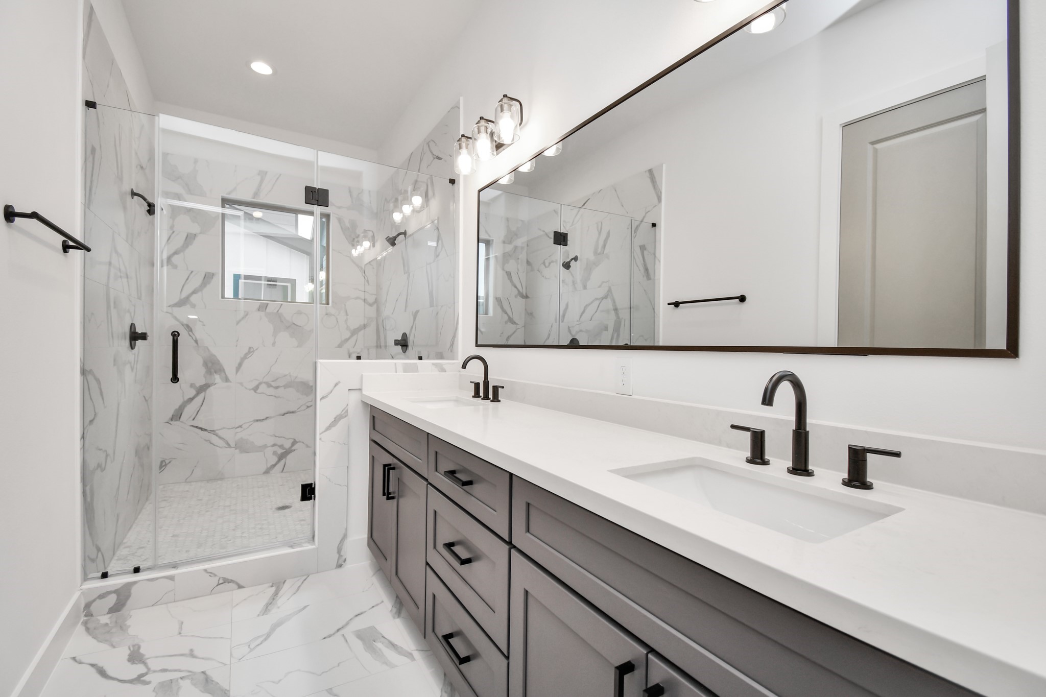 2335 Eagle Street Houston, TX 77004 - Photo 24 of 26 a bathroom with a double vanity sink mirror and shower