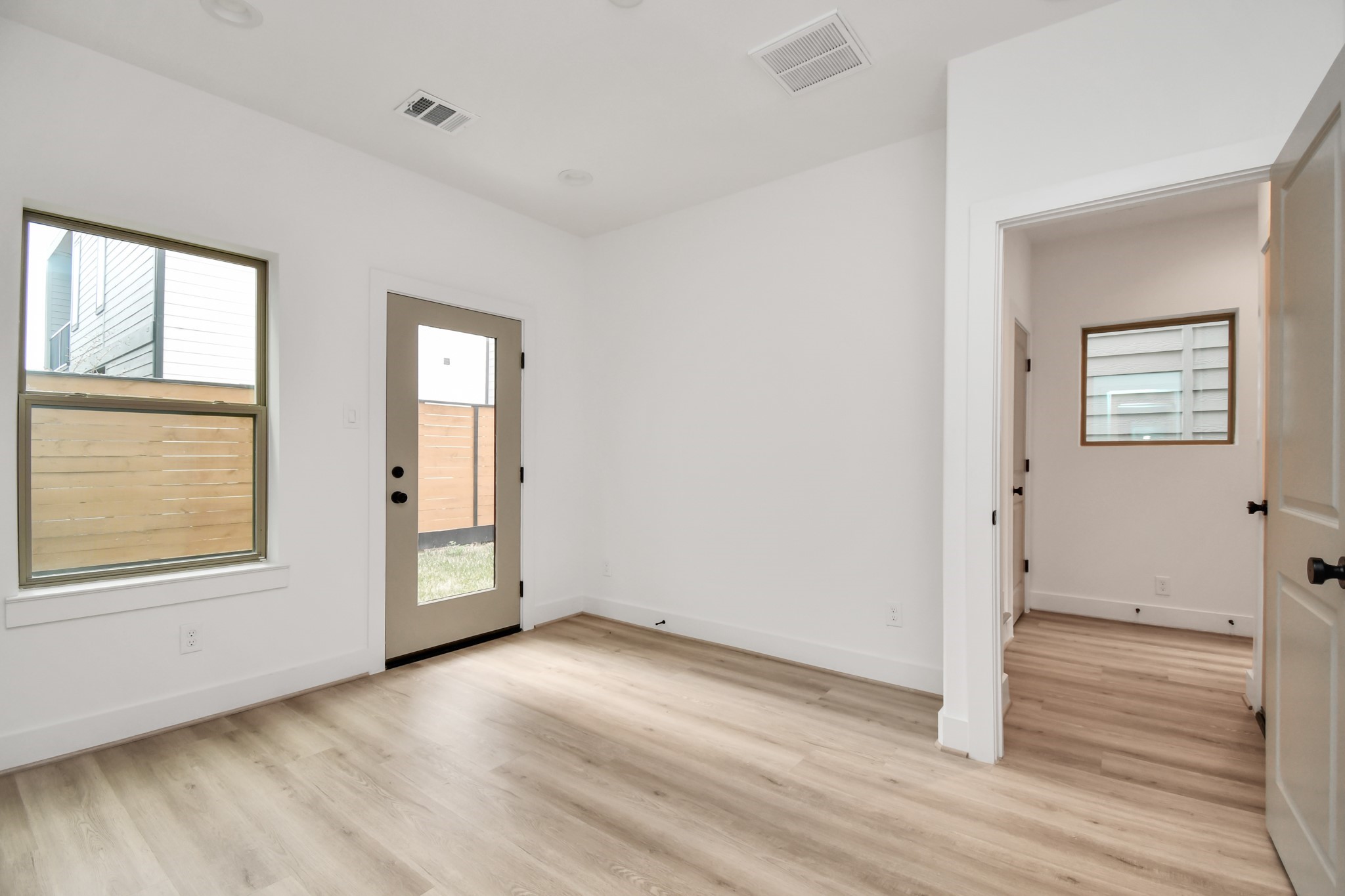 2335 Eagle Street Houston, TX 77004 - Photo 5 of 26 an empty room with wooden floor and windows