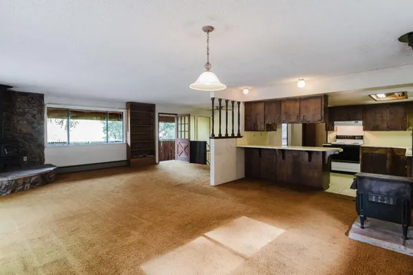 a large kitchen with a counter top stainless steel appliances and cabinets