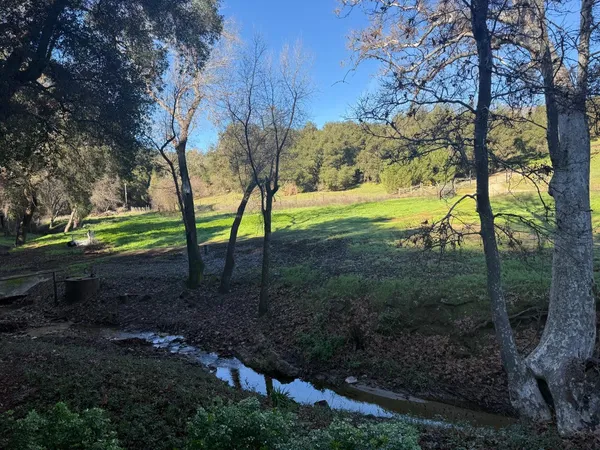 a view of balcony with wooden floor and fence