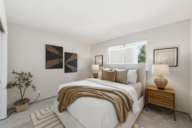 a bedroom with a bed and a potted plant