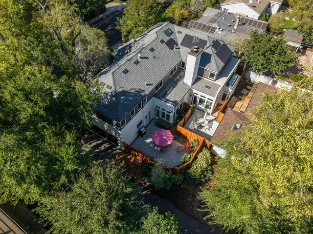 an aerial view of a house with a yard
