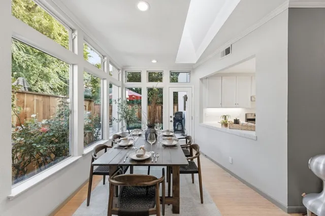 a view of a dining room with furniture large window and wooden floor
