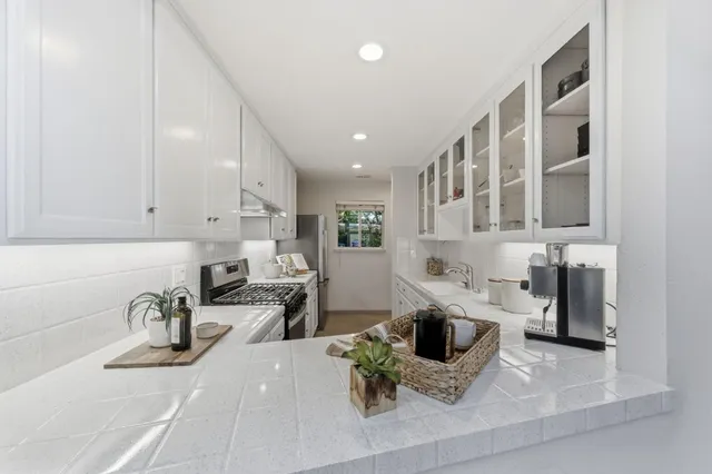 a kitchen with a sink and a stove top oven