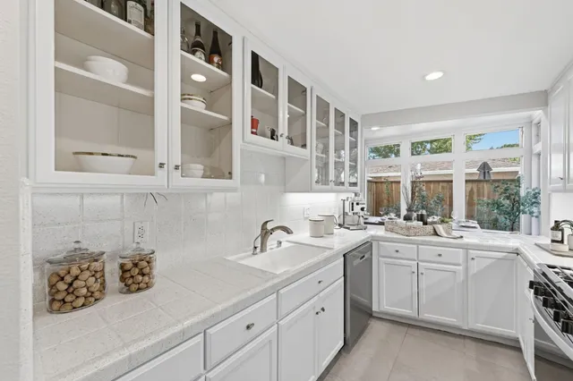 a kitchen with cabinets a sink and appliances