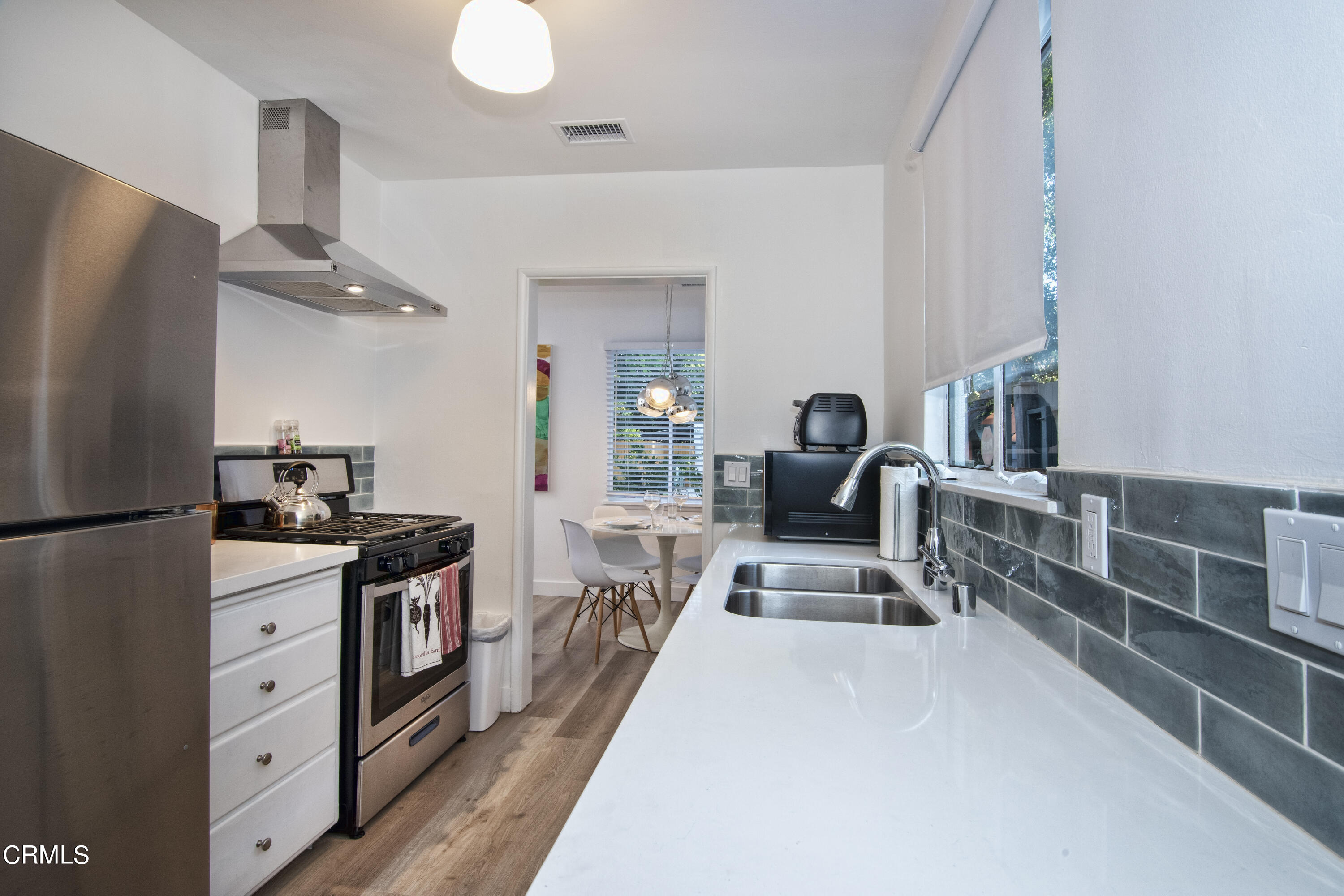 2935 Morningside Street Pasadena, CA 91107 - Photo 12 of 31 a large kitchen with stainless steel appliances a stove a refrigerator a oven with white cabinets