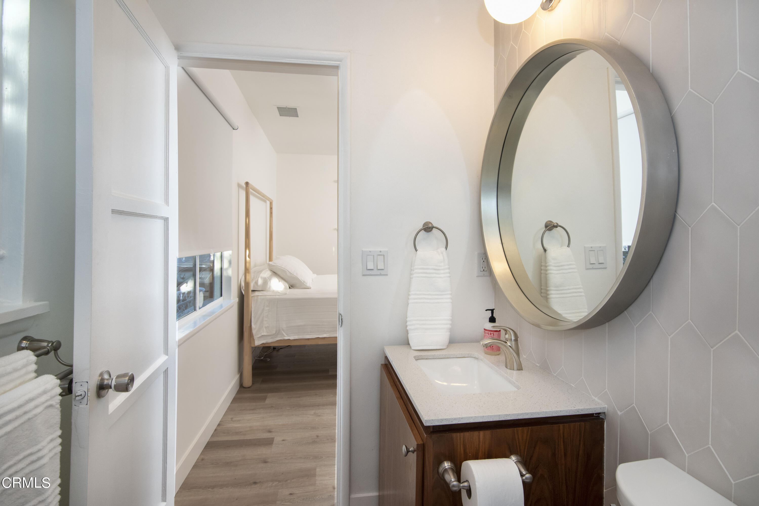 2935 Morningside Street Pasadena, CA 91107 - Photo 24 of 31 a bathroom with a sink a mirror and a toilet