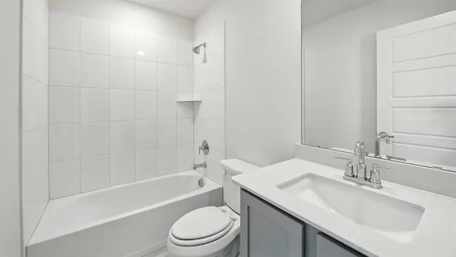 a bathroom with a sink toilet vanity and shower
