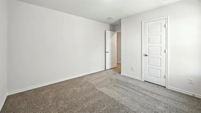 an empty room with closet area