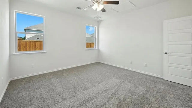 an empty room with a chandelier fan