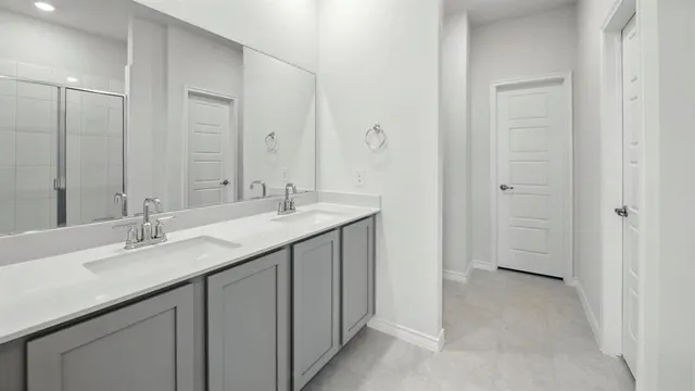 a bathroom with a double vanity sink and mirror