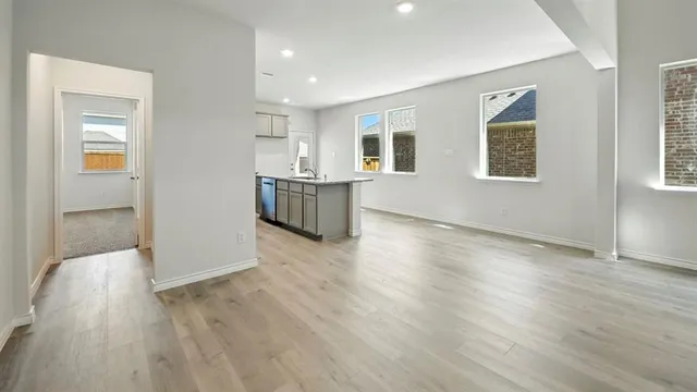 a view of a kitchen with wooden floor and a kitchen