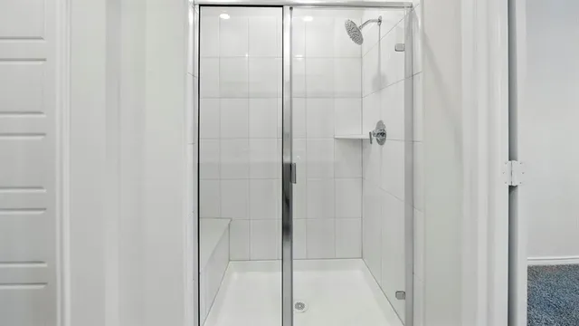 a bathroom with a glass shower door