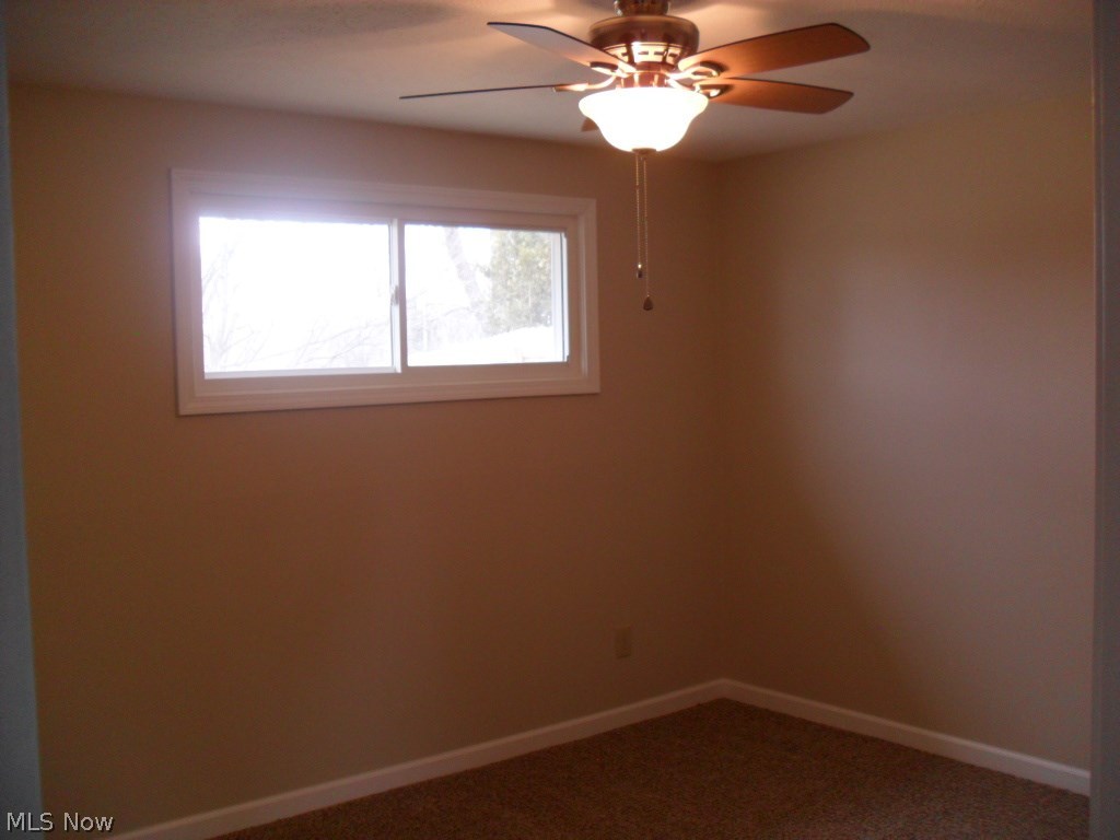 3125 Polly Road Ravenna, OH 44266 - Photo 17 of 34 Bedroom one with NEW 2018 carpet, paint, windows, ceiling fans, & wood trim.
