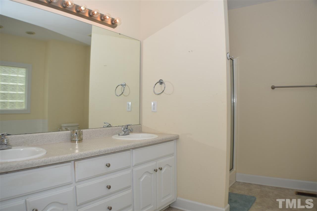 395 Steve Ridge Willow Spring, NC 27592 - Photo 14 of 21 a bathroom with a granite countertop sink and a mirror