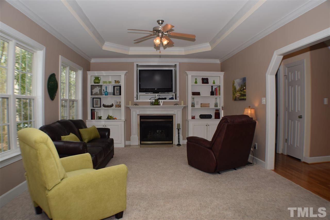 395 Steve Ridge Willow Spring, NC 27592 - Photo 7 of 21 a living room with furniture a flat screen tv and a fireplace