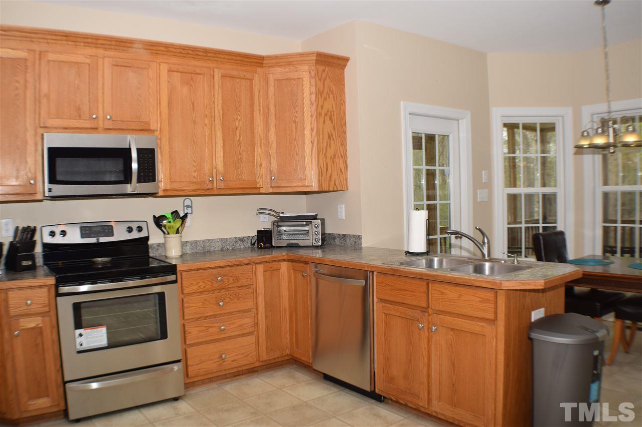 395 Steve Ridge Willow Spring, NC 27592 - Photo 9 of 21 a kitchen with stainless steel appliances granite countertop a stove sink and cabinets