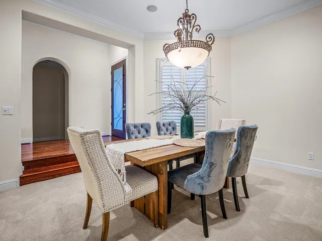 a spacious bathroom with a tub sink and mirror