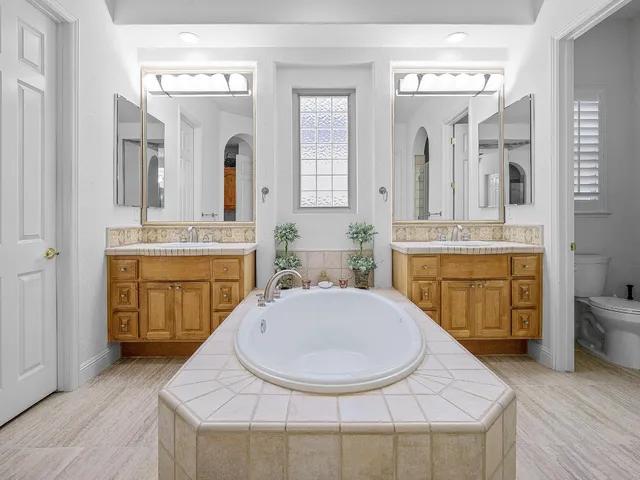 a kitchen with a sink and a wooden floor