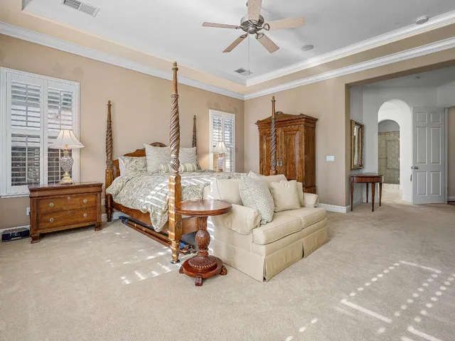 a view of a livingroom with wooden floor and a mirror