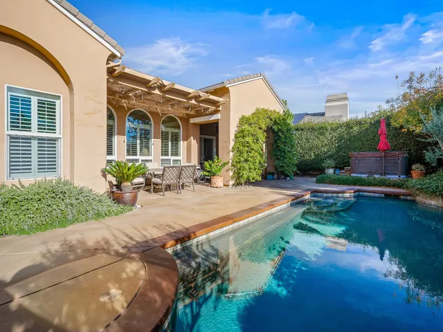 a kitchen with kitchen island granite countertop a sink stove and refrigerator