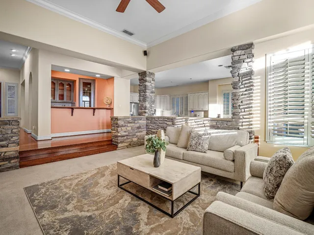 a dining room with furniture a chandelier and wooden floor