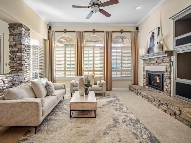 a kitchen with stainless steel appliances granite countertop a kitchen island a stove a refrigerator a oven and a sink