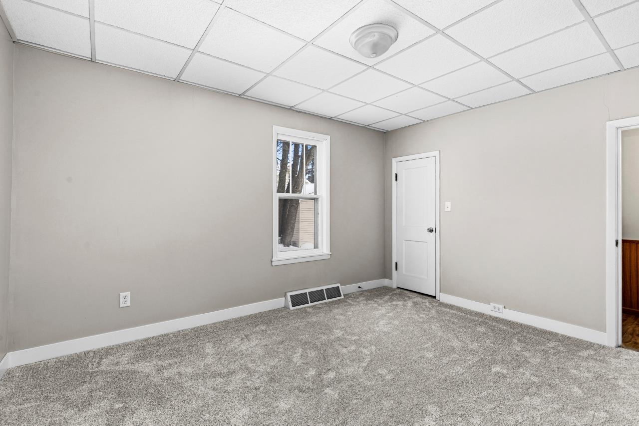 310 3rd Street Cloquet, MN 55720 - Photo 13 of 39 Carpeted spare room featuring a drop ceiling and baseboards
