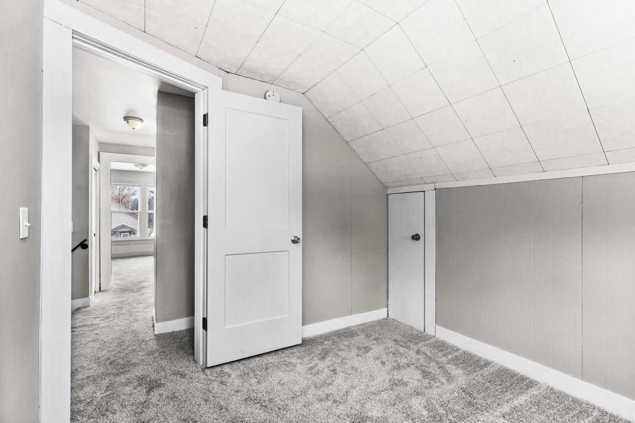 310 3rd Street Cloquet, MN 55720 - Photo 36 of 39 Bonus room featuring carpet floors, lofted ceiling, and wood walls