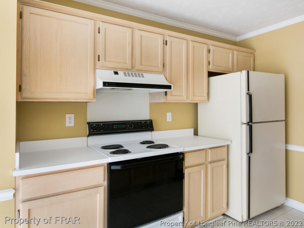 218 Larchmont Road Fayetteville, NC 28311 - Photo 11 of 28 a kitchen with stainless steel appliances a refrigerator sink and white cabinets