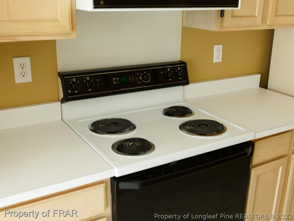 218 Larchmont Road Fayetteville, NC 28311 - Photo 12 of 28 a kitchen with a stove and a refrigerator