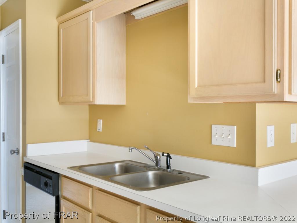 218 Larchmont Road Fayetteville, NC 28311 - Photo 13 of 28 a kitchen with a sink and cabinets