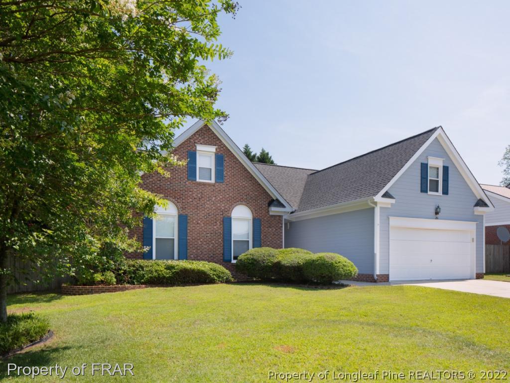 218 Larchmont Road Fayetteville, NC 28311 - Photo 2 of 28 a front view of a house with yard and garage