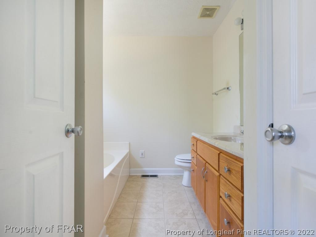 218 Larchmont Road Fayetteville, NC 28311 - Photo 23 of 28 a bathroom with a sink a toilet and shower