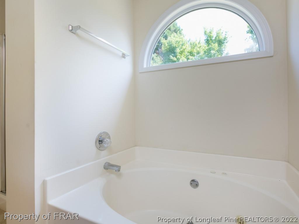 218 Larchmont Road Fayetteville, NC 28311 - Photo 24 of 28 a white bath tub sitting next to a window