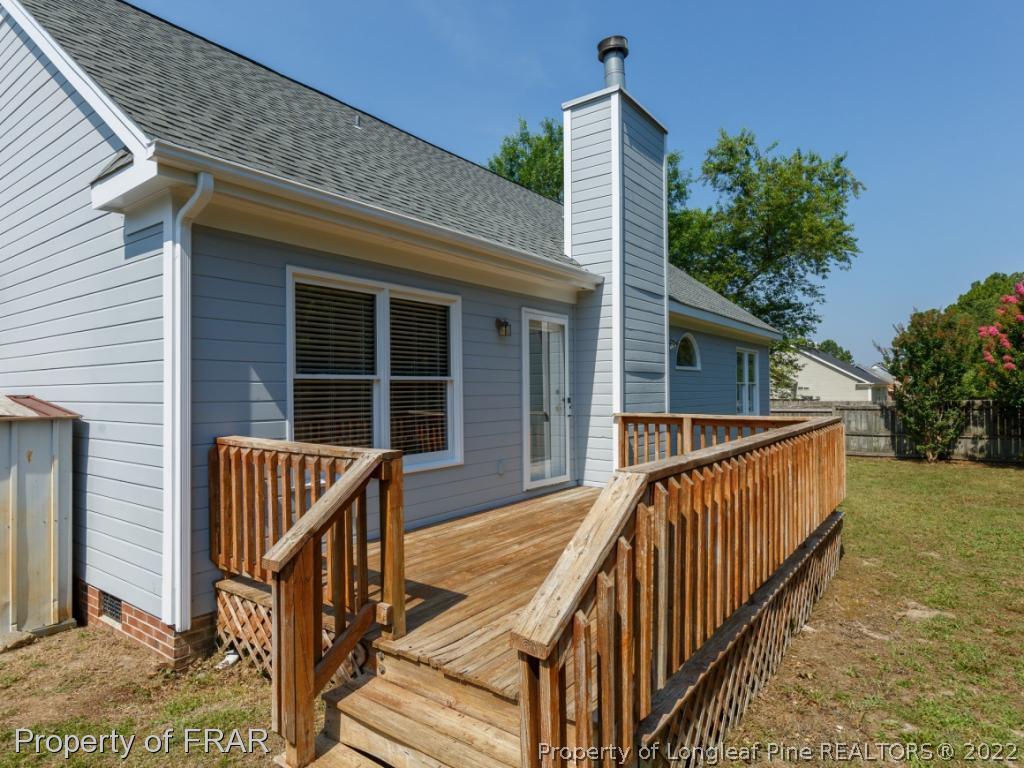 218 Larchmont Road Fayetteville, NC 28311 - Photo 27 of 28 a view of house with wooden deck and furniture