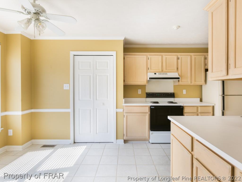 218 Larchmont Road Fayetteville, NC 28311 - Photo 8 of 28 a kitchen with a sink a stove cabinets and black appliances