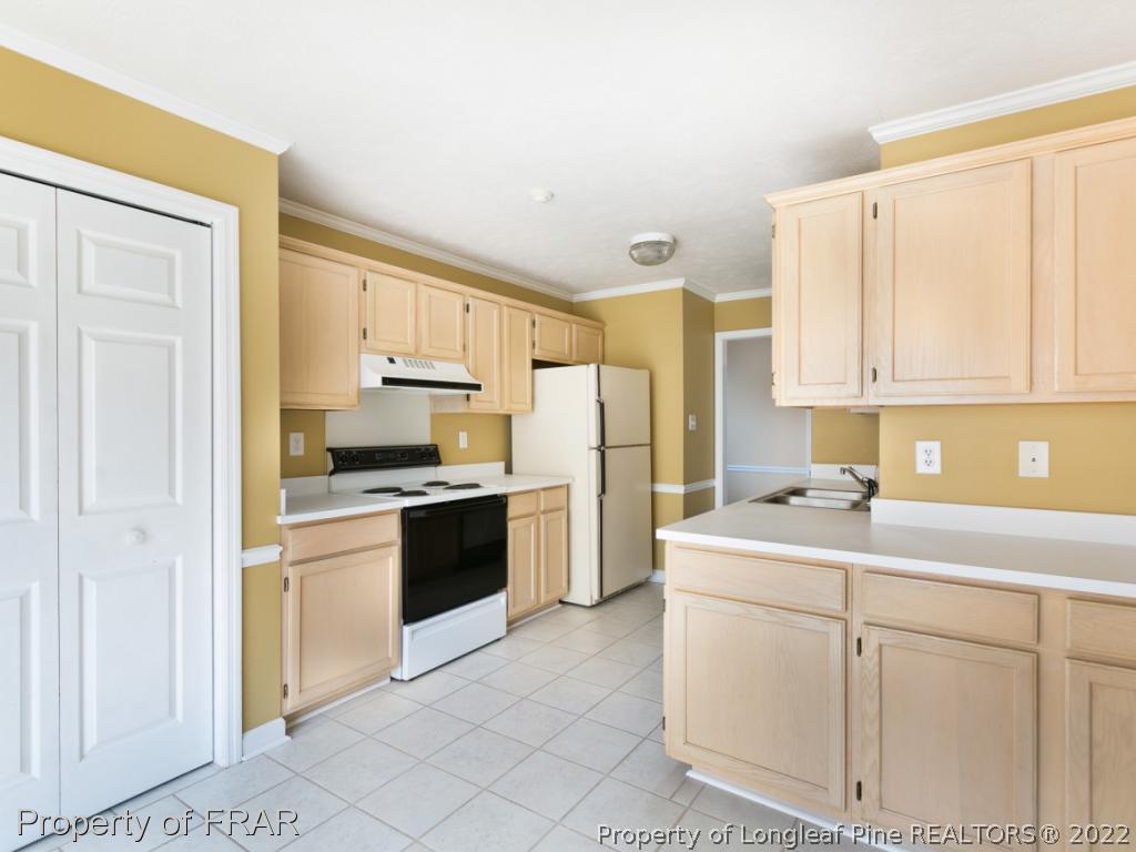 218 Larchmont Road Fayetteville, NC 28311 - Photo 9 of 28 a kitchen with a sink cabinets and refrigerator