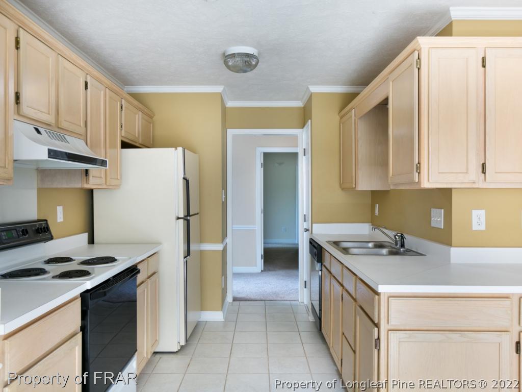 218 Larchmont Road Fayetteville, NC 28311 - Photo 10 of 28 a kitchen that has a lot of cabinets in it and stainless steel appliances