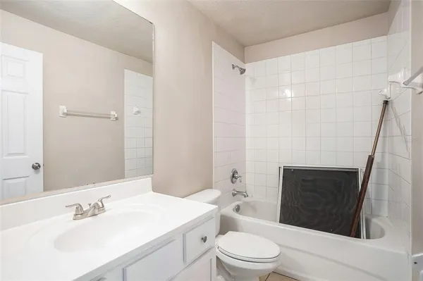 a bathroom with a sink a toilet a mirror and shower