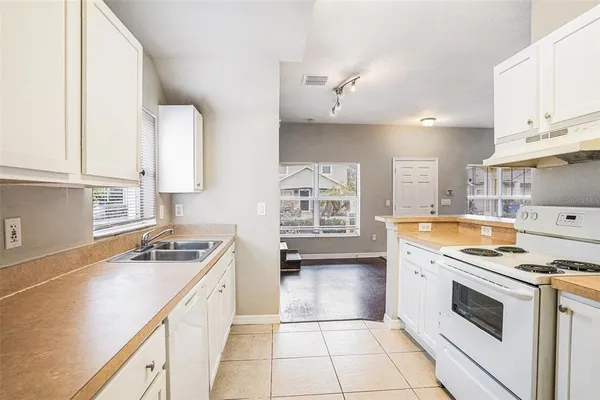 a kitchen with a stove a sink and a refrigerator
