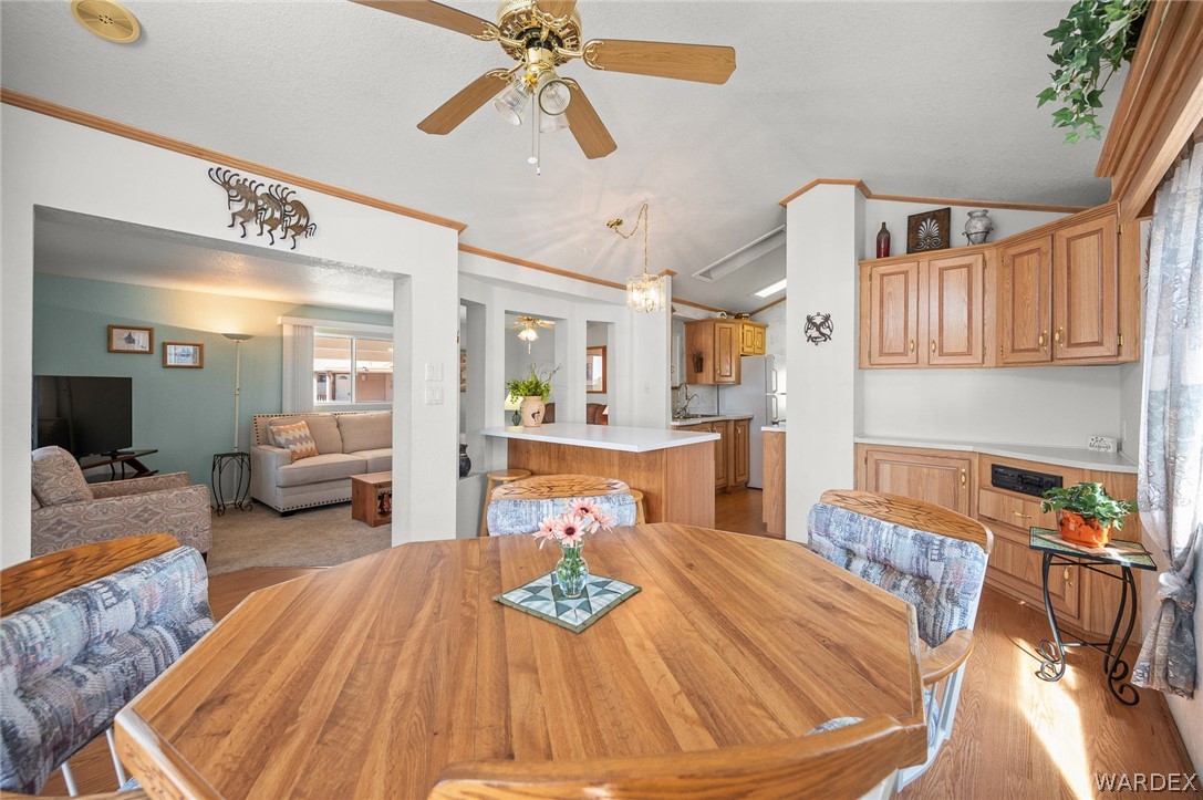 2000 Ramar Road, Unit 158 Bullhead City, AZ 86442 - Photo 25 of 78 wSpacious dining area with vaulted ceilings and beautiful wood accents? seamlessly connected to the kitchen and living spaces.