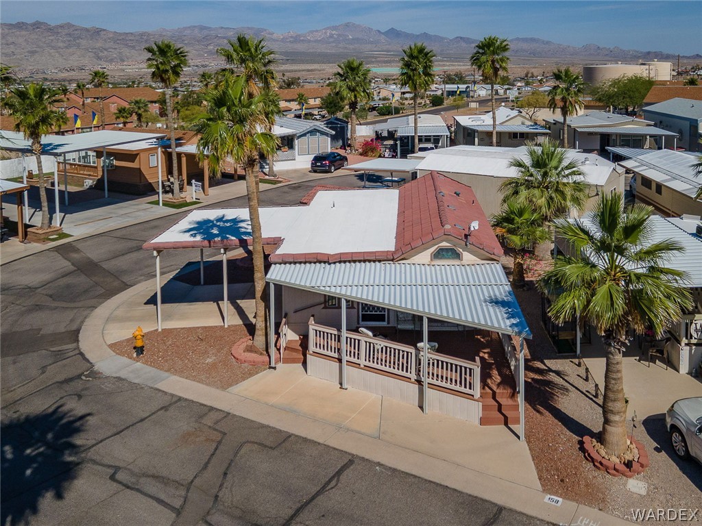 2000 Ramar Road, Unit 158 Bullhead City, AZ 86442 - Photo 3 of 78 Inviting front elevation with extended covered parking, spacious wraparound deck, and low-maintenance desert landscaping? designed for easy resort-style living.