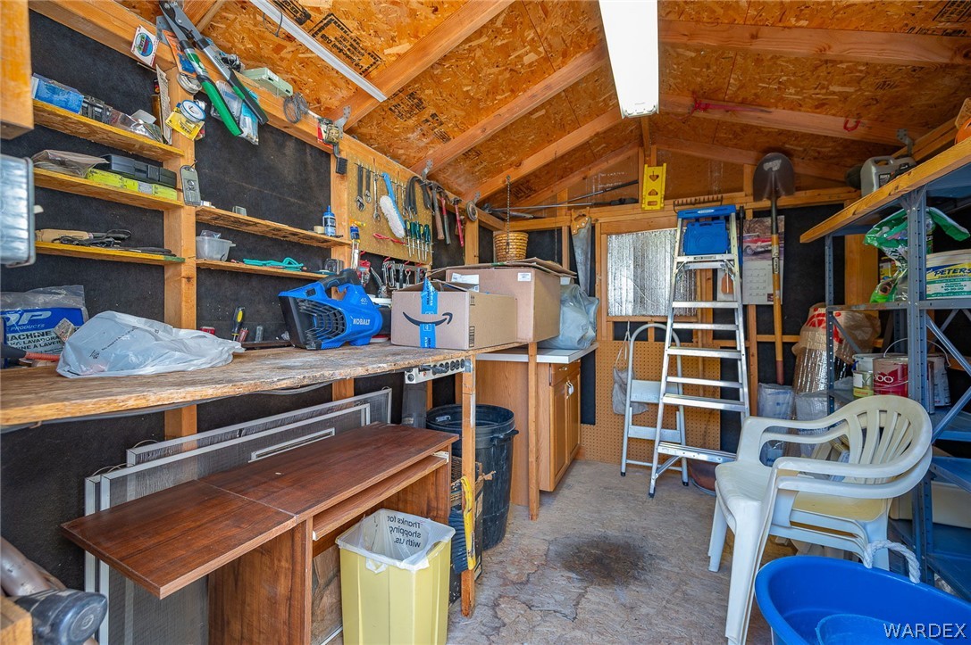 2000 Ramar Road, Unit 158 Bullhead City, AZ 86442 - Photo 45 of 78 Functional workshop space with built-in workbench and shelving? ideal for projects and organization.